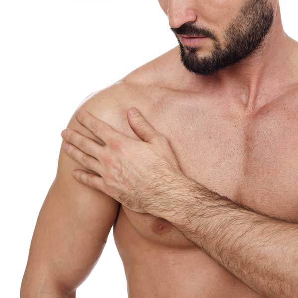 Man holding his shoulder in discomfort.