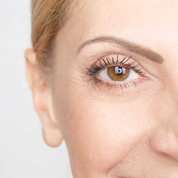 Close-up of a mature woman's smiling eye and face.